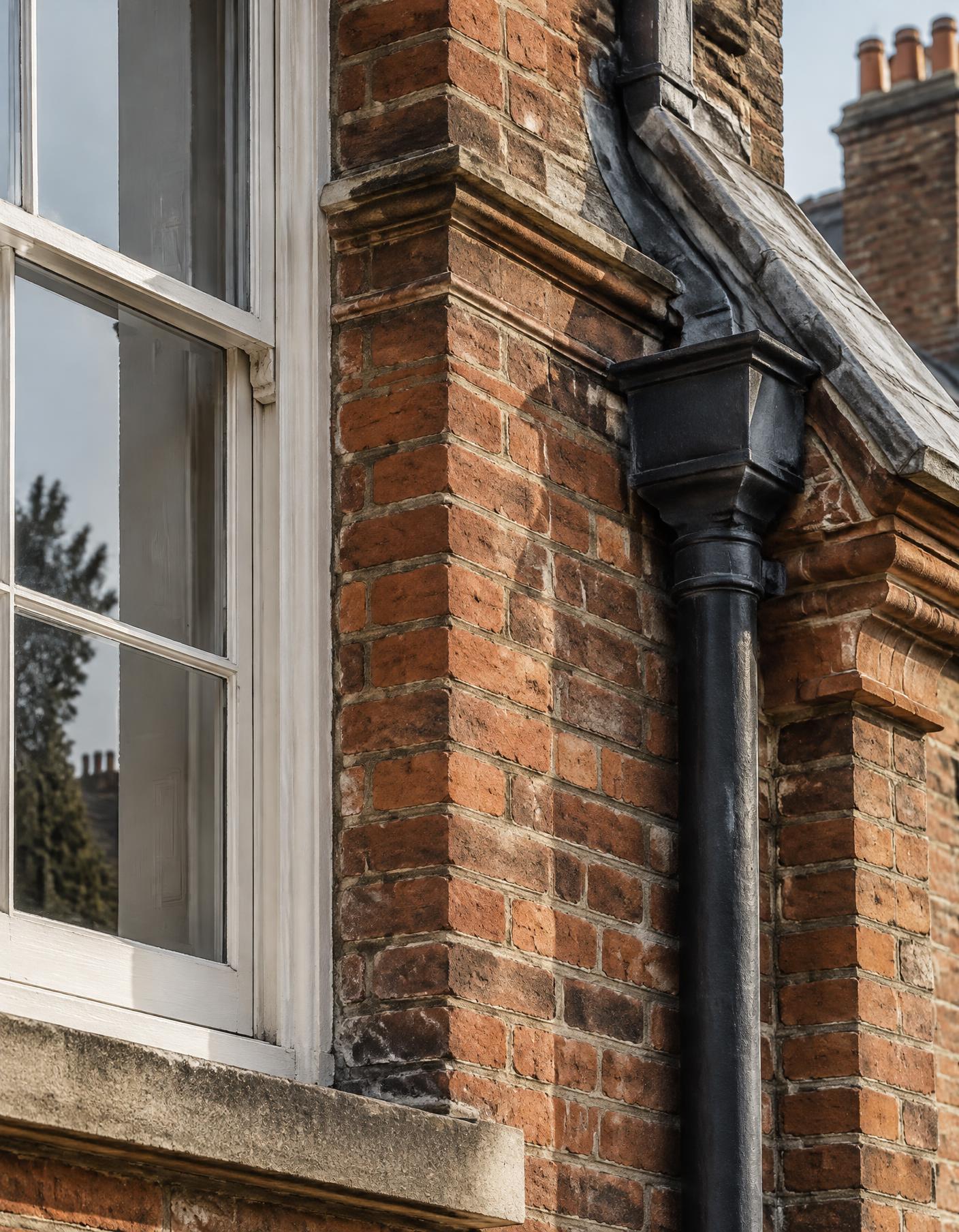 Close inspection of brickwork, window joinery and rainwater goods
