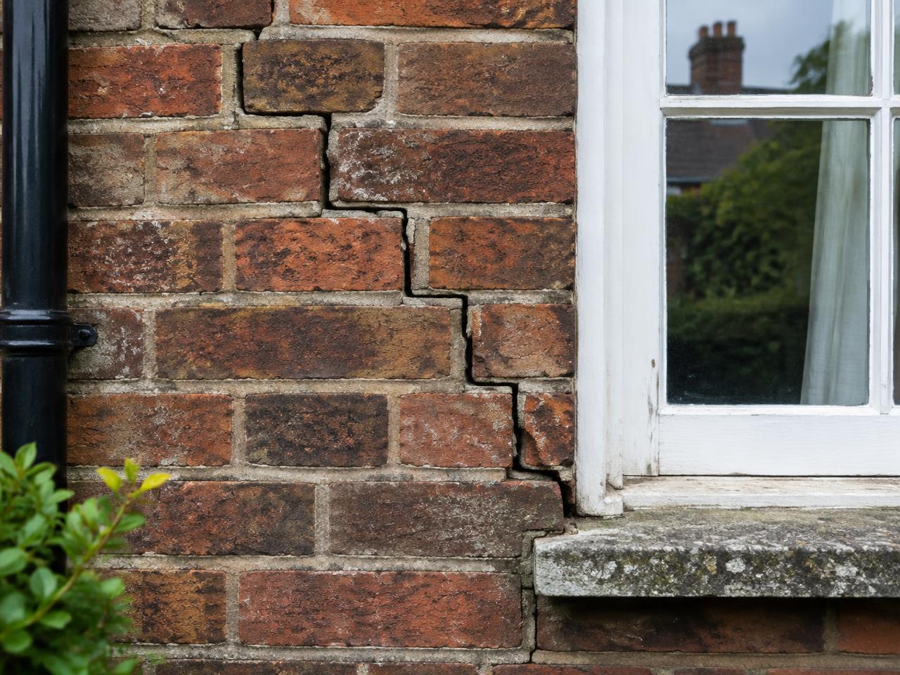 Stepped cracking beside a bay window on a British brick home